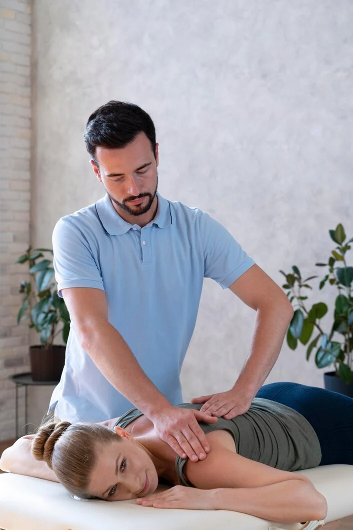 Practitioner working with a patient on a treatment table