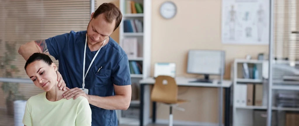 Practitioner assessing a seated patient