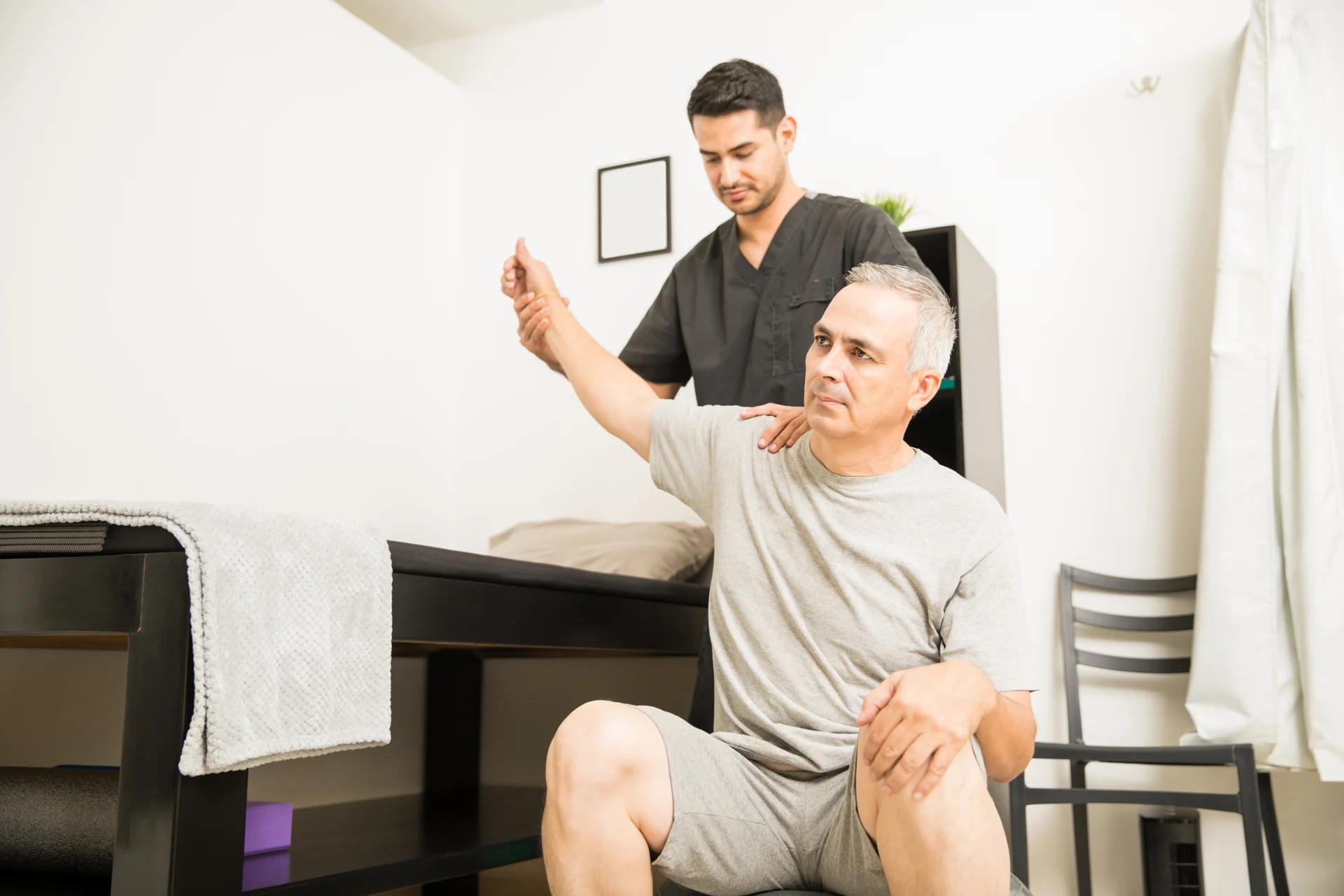 Practitioner assessing a seated patient